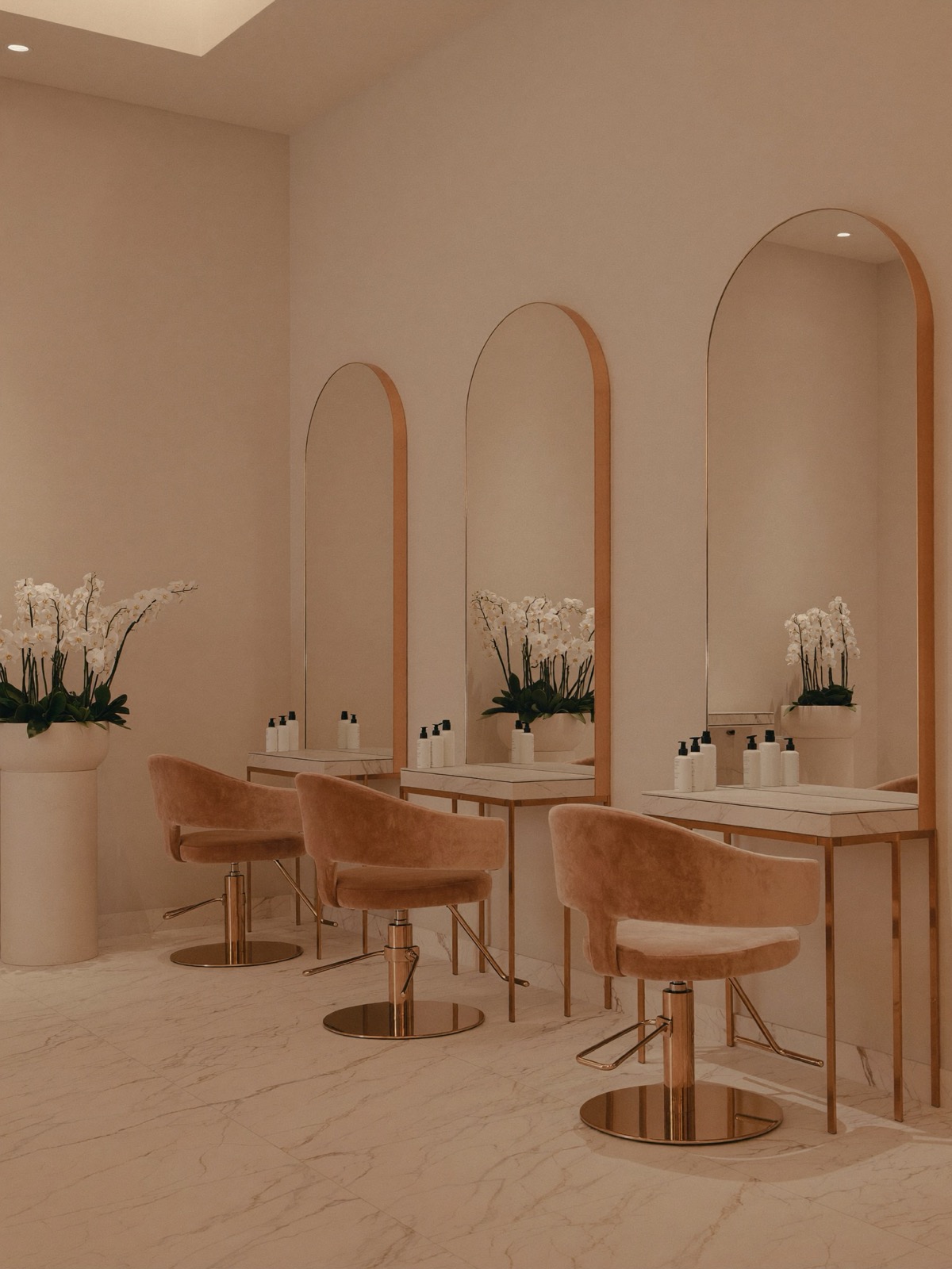 OPAL Beauty salon interior — cream marble, soft daylight and copper details